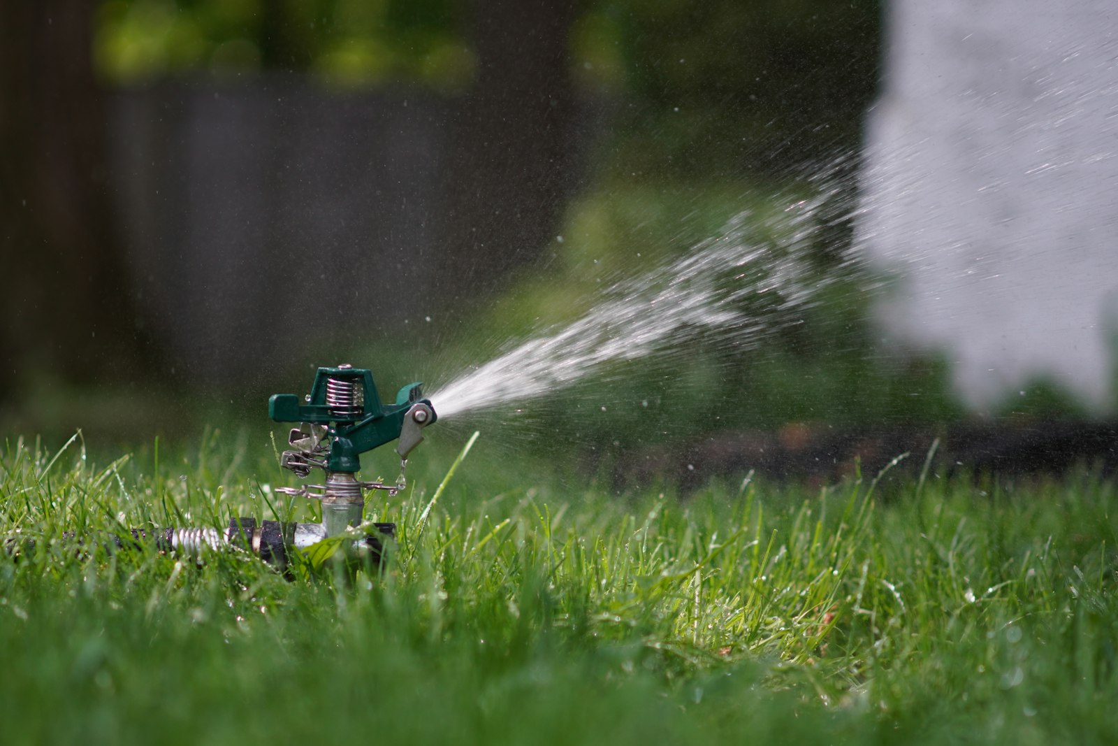 Technician adjusting an irrigation controller and valve