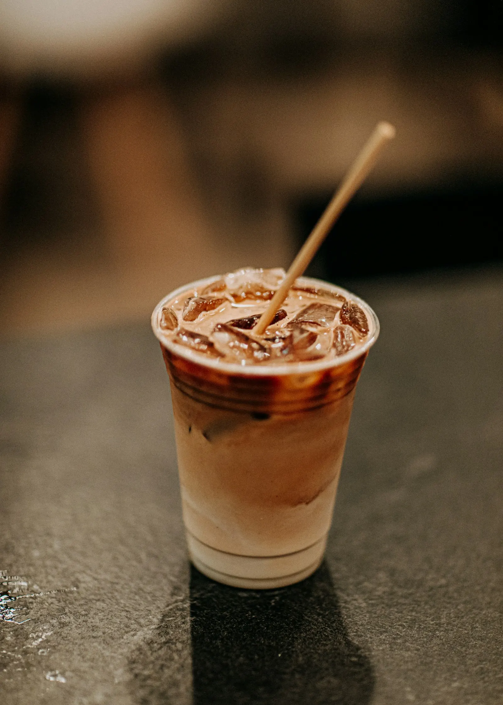 Layered iced coffee in a domed to-go cup